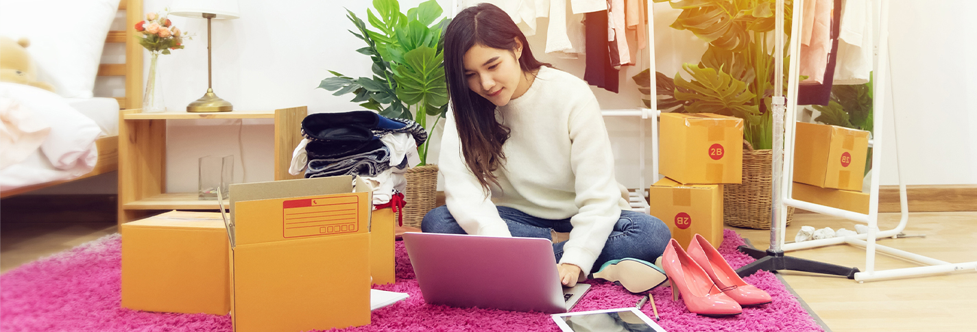 lady using laptop with delivery boxes