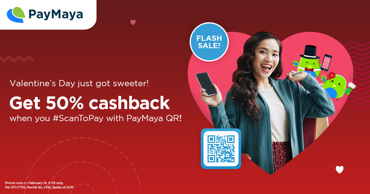 Lady in teal long sleeve facing in front smiling holding both bag and a phone with a big heart shape behind her